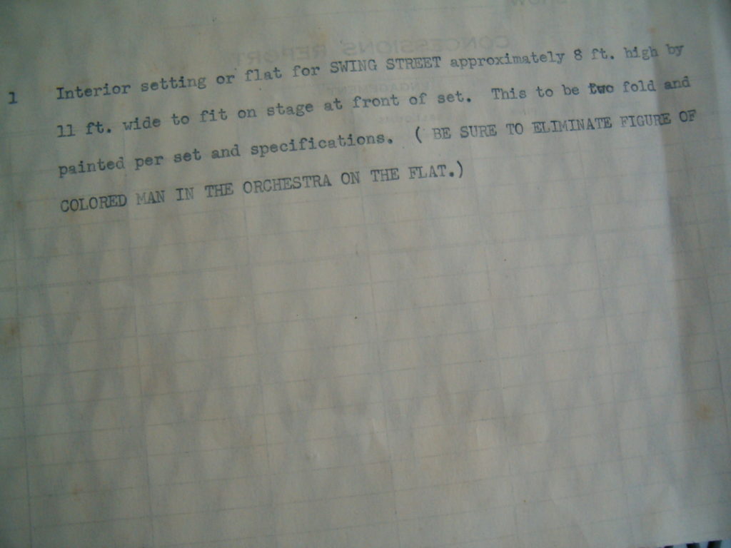 Typed instructions asking the set designer to take "the colored man" our of the flat drawing.